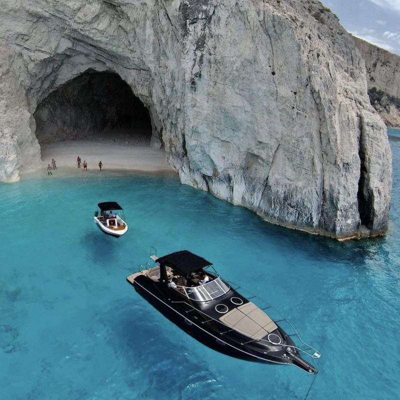 Black Luxury Yacht near a cave